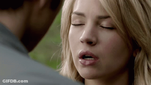 A Close Up Of A Woman 'S Face With Her Eyes Closed And Her Mouth Open GIF