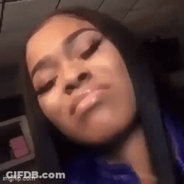 A Close Up Of A Woman 'S Face With Her Eyes Closed And Her Mouth Open . GIF