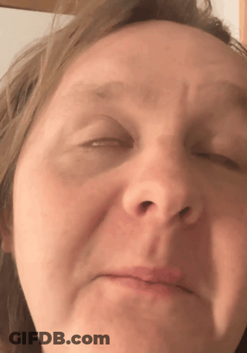 A Close Up Of A Woman 'S Face With Her Eyes Closed And Her Mouth Open GIF