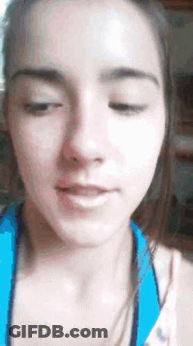 A Close Up Of A Woman 'S Face With Her Eyes Closed And Her Mouth Open GIF