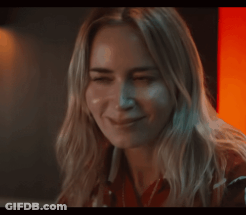 A Close Up Of A Woman 'S Face With Her Eyes Closed And Smiling GIF