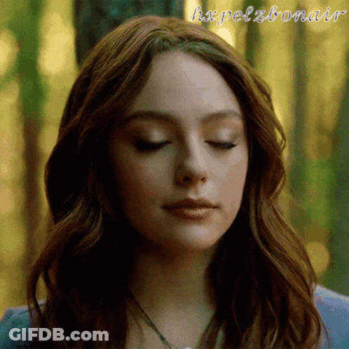 A Close Up Of A Woman 'S Face With Her Eyes Closed And The Words Hxpelzbonair Written On The Bottom GIF