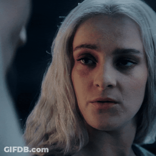 A Close Up Of A Woman 'S Face With Her Eyes Closed GIF