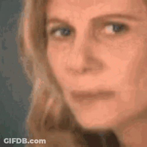 A Close Up Of A Woman 'S Face With Her Eyes Closed GIF