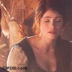 A Close Up Of A Woman 'S Face With Her Eyes Closed In A Dark Room . GIF