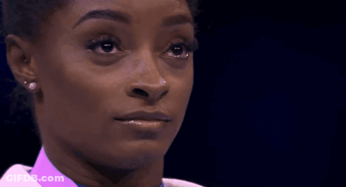 A Close Up Of A Woman 'S Face With Her Eyes Closed GIF