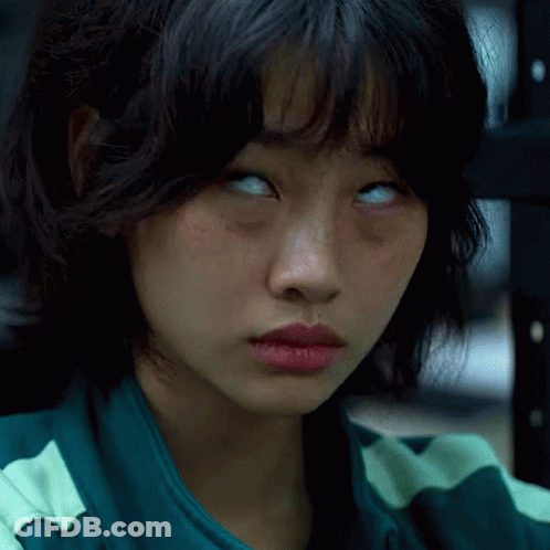 A Close Up Of A Woman 'S Face With Her Eyes Closed GIF