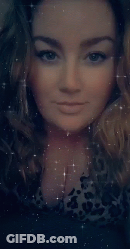 A Close Up Of A Woman 'S Face With Her Eyes Closed Surrounded By Stars GIF