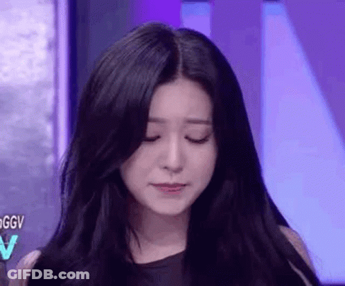 A Close Up Of A Woman 'S Face With Her Eyes Closed . GIF