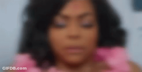 A Close Up Of A Woman 'S Face With Her Eyes Closed Wearing A Pink Dress . GIF