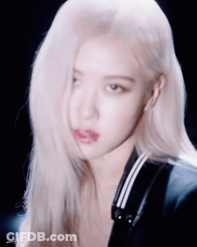 A Close Up Of A Woman 'S Face With Her Hair Blowing In The Wind GIF