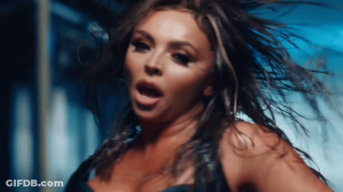 A Close Up Of A Woman 'S Face With Her Hair Flying In The Wind GIF