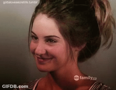 A Close Up Of A Woman 'S Face With Her Hair In A Ponytail . GIF