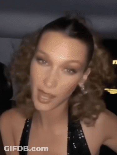 A Close Up Of A Woman 'S Face With Her Hair In A Ponytail . GIF
