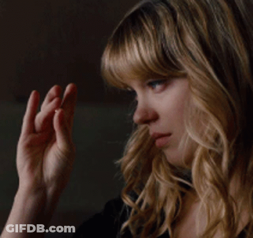 A Close Up Of A Woman 'S Face With Her Hand On Her Chin GIF