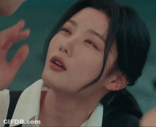 A Close Up Of A Woman 'S Face With Her Hand On Her Face GIF