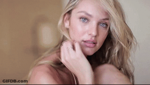 A Close Up Of A Woman 'S Face With Her Hand On Her Face And A Ring On Her Finger . GIF