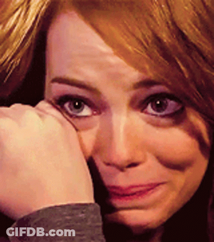 A Close Up Of A Woman 'S Face With Her Hand On Her Face GIF