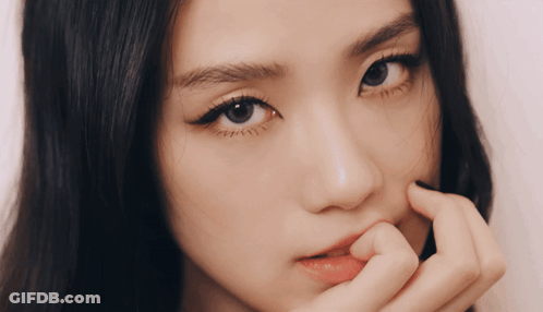 A Close Up Of A Woman 'S Face With Her Hand On Her Face GIF