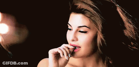 A Close Up Of A Woman 'S Face With Her Hand On Her Lips . GIF
