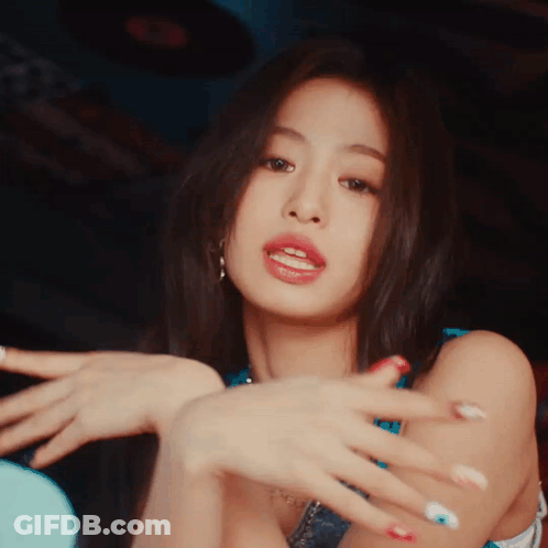 A Close Up Of A Woman 'S Face With Her Hands In The Air GIF