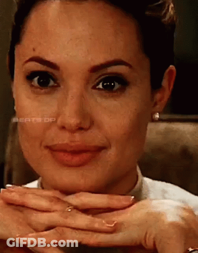 A Close Up Of A Woman 'S Face With Her Hands On Her Face GIF
