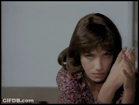 A Close Up Of A Woman 'S Face With Her Hands On Her Face GIF