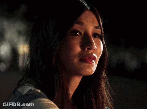 A Close Up Of A Woman 'S Face With Her Mouth Open GIF