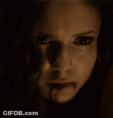 A Close Up Of A Woman 'S Face With Her Mouth Open GIF