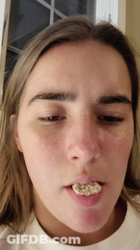 A Close Up Of A Woman 'S Face With Her Mouth Open GIF