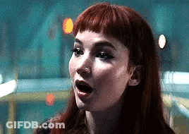 A Close Up Of A Woman 'S Face With Her Mouth Open . GIF