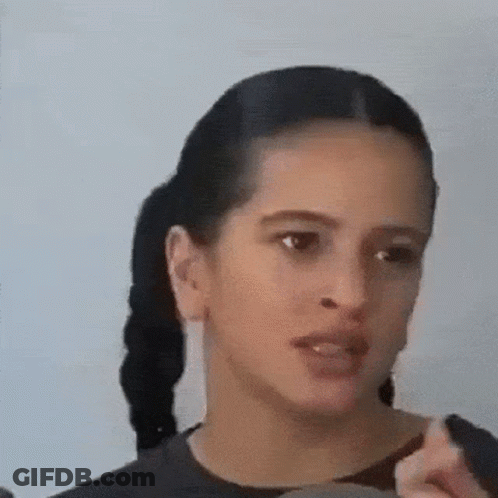 A Close Up Of A Woman 'S Face With Her Mouth Open . GIF