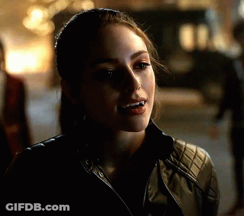 A Close Up Of A Woman 'S Face With Her Mouth Open GIF