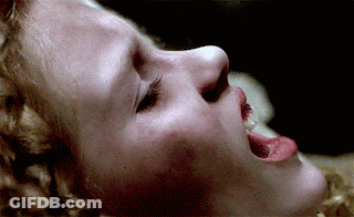 A Close Up Of A Woman 'S Face With Her Mouth Open GIF