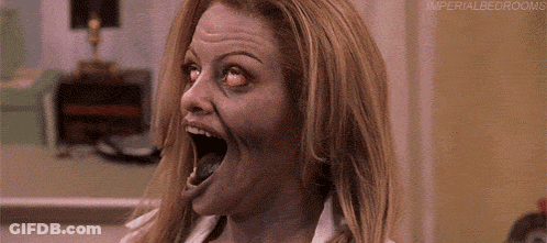 A Close Up Of A Woman 'S Face With Her Mouth Open And Eyes Closed . GIF