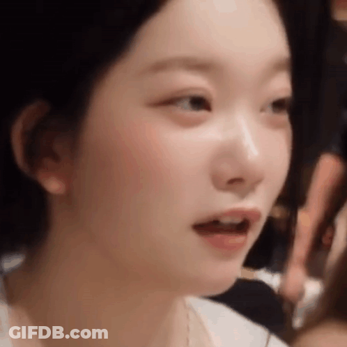 A Close Up Of A Woman 'S Face With Her Mouth Open And Her Eyes Closed . GIF