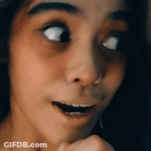 A Close Up Of A Woman 'S Face With Her Mouth Open And Her Eyes Closed . GIF