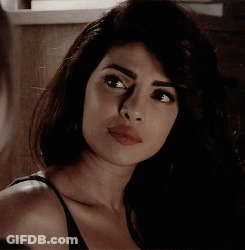 A Close Up Of A Woman 'S Face With Her Mouth Open GIF