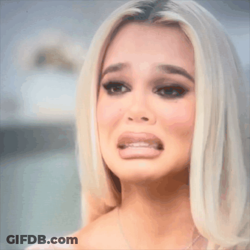 A Close Up Of A Woman 'S Face With Her Mouth Open GIF