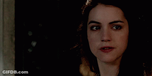 A Close Up Of A Woman 'S Face With Her Mouth Open GIF