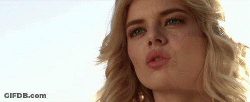 A Close Up Of A Woman 'S Face With Her Mouth Open GIF
