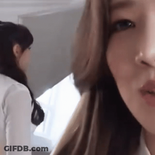 A Close Up Of A Woman 'S Face With Her Mouth Open GIF