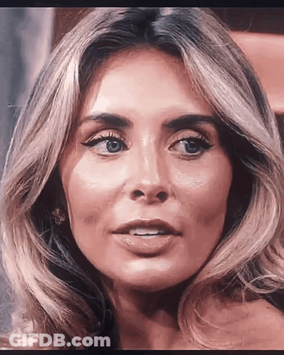 A Close Up Of A Woman 'S Face With Her Mouth Open GIF