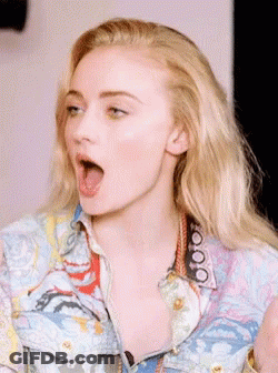 A Close Up Of A Woman 'S Face With Her Mouth Wide Open GIF