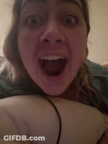 A Close Up Of A Woman 'S Face With Her Mouth Wide Open GIF