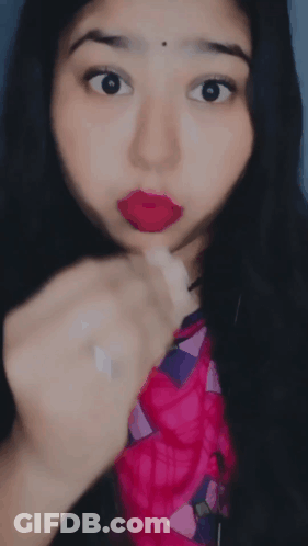 A Close Up Of A Woman 'S Face With Her Tongue Hanging Out GIF