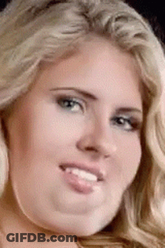 A Close Up Of A Woman 'S Face With Her Tongue Hanging Out GIF