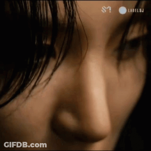 A Close Up Of A Woman 'S Face With Labelsj Written On The Bottom Right GIF
