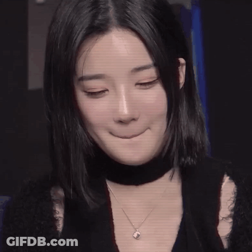 A Close Up Of A Woman 'S Face With Long Black Hair GIF