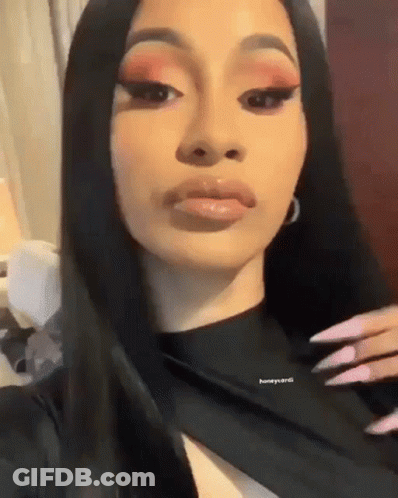A Close Up Of A Woman 'S Face With Long Black Hair . GIF
